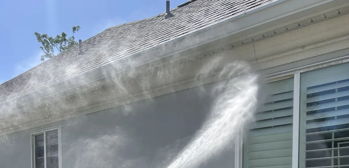 Washing the roofline and gutter of a stucco home
