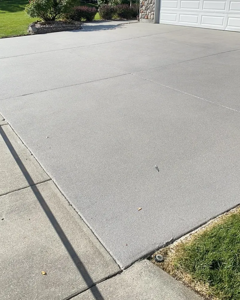 Clean, even concrete driveway after Lucent driveway cleaning